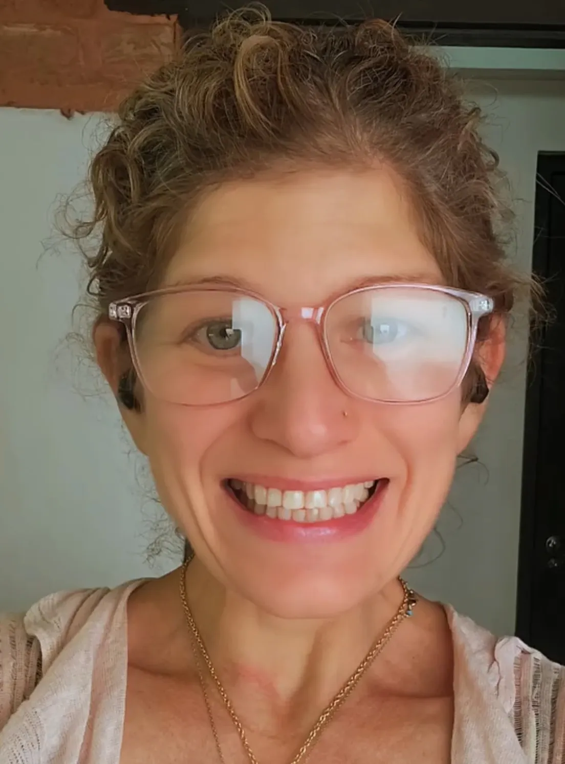 Christina smiling while holding a crystal singing bowl